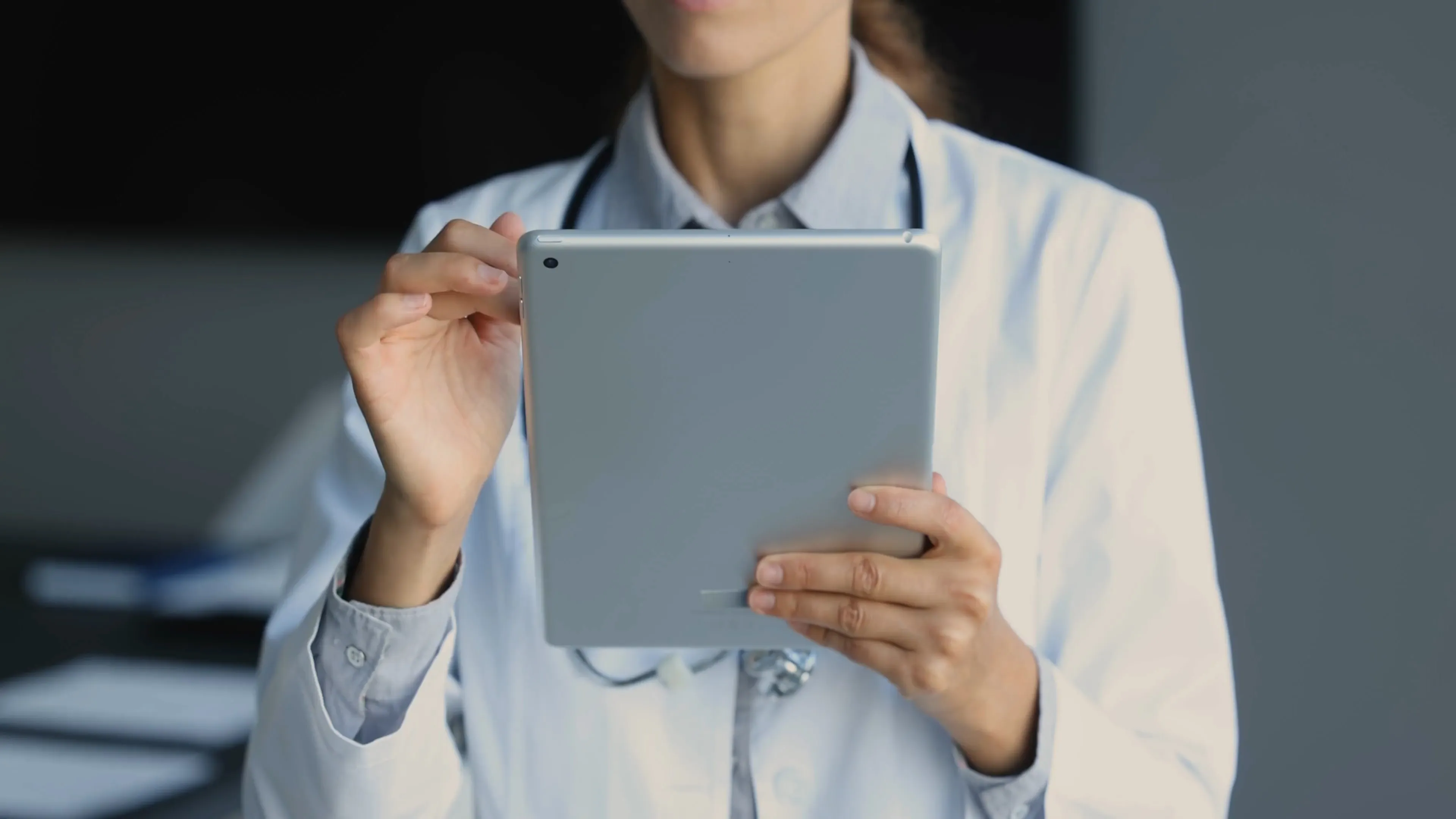 Clinician reading a patient record on a tablet