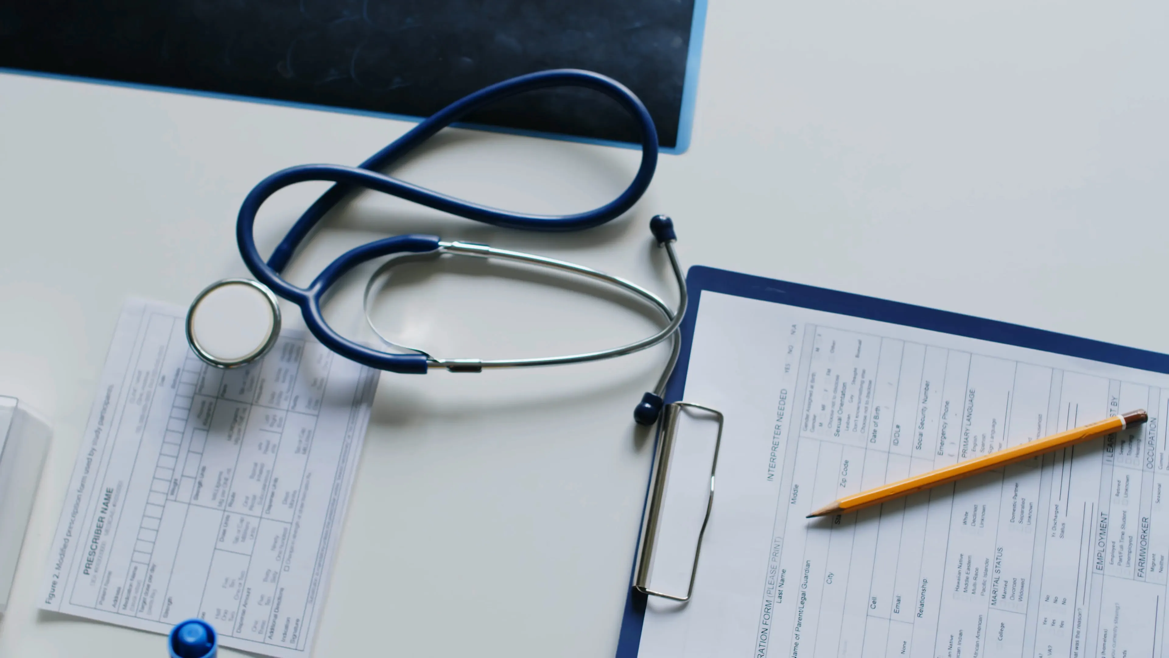 A stethoscope resting on a patient intake form
